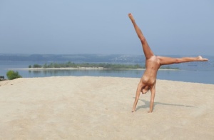 Flexible blonde Afina meditating naked and stretching on the beach #4