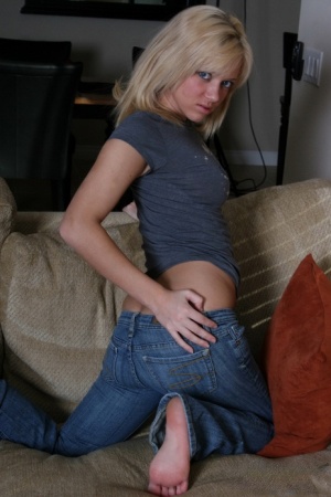 Young blond Danielle Lynn cradles her perky tits before pulling down her jeans #4