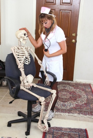 Sexy nurse Christy James peels her white uniform to facesit on a skeleton #2