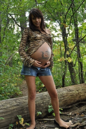 Pregnant amateur Brianna shows tits and twat plus swollen belly in the woods naked photo #4