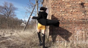 Solo girl with black hair pulls down her miniskirt to pee by a brick structure Ass gallerie #2